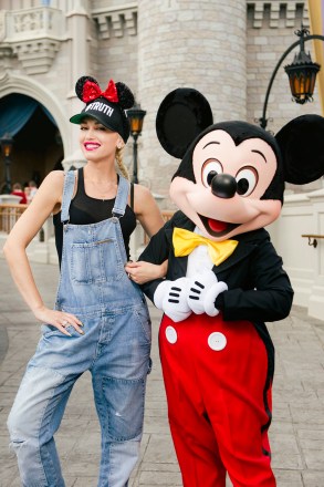 Superstar Gwen Stefani took her family to Walt Disney World, Orlando, during a fun timeout from her 'This Is What The Truth Feels Like' US tour, on Monday (july 25). The 46-year-old performer and judge on hit TV show The Voice wore denim dungarees for her visit to the famous Magic Kingdom theme park despite the soaring Florida heat, proving once again that she's the 'Queen of Cool'. Her long, platinum blonde locks were immaculately braided and she wore her trademark red lipstick even as the temperatures reached 100 degrees. She is seen posing with Mickey Mouse wearing a baseball cap with the hashtag #TRUTH, as a nod to her tour. Photo: Chloe Rice / Disney WorldPictured: gwen stefani,mickey mouse,gwen stefanimickey mouseRef: SPL1324626 250716 NON-EXCLUSIVEPicture by: SplashNews.comSplash News and PicturesUSA: +1 310-525-5808London: +44 (0)20 8126 1009Berlin: +49 175 3764 166photodesk@splashnews.comWorld Rights