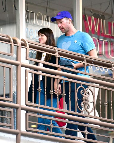EXCLUSIVE: Dakota Johnson & Chris Martin pack on the PDA during a rare night out together at sushi park restaurant!. 26 May 2022 Pictured: Chris Martin, Dakota Johnson. Photo credit: MEGA TheMegaAgency.com +1 888 505 6342 (Mega Agency TagID: MEGA862448_006.jpg) [Photo via Mega Agency]