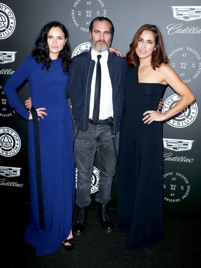 Joaquin Phoenix with sisters Rain and Summer at the Art of Elysium