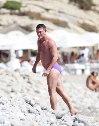 EXCLUSIVE: Luke Evans and his new Spanish boyfriend Fran Tomas PDA kisses and caresses while enjoying a swim on the beaches of Ibiza on August 24, 2022 in Ibiza, Spain. 24 Aug 2022 Pictured: Luke Evans. Photo credit: Elkin Cabarcas / MEGA TheMegaAgency.com +1 888 505 6342 (Mega Agency TagID: MEGA888996_001.jpg) [Photo via Mega Agency]
