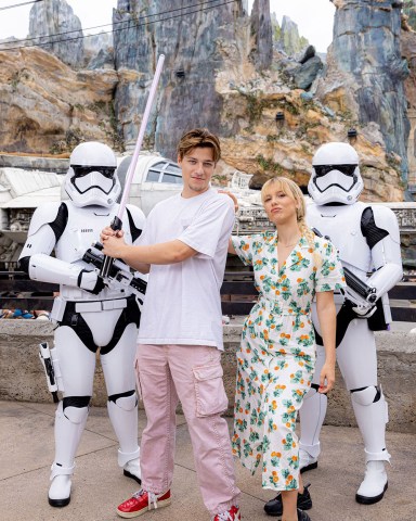Actors Millie Bobby Brown and Jake Bongiovi joined the Dark Side at Walt Disney World Resort in Lake Buena Vista, Fla. on September 27, 2022. The couple posed with First Order Stormtroopers and Darth Vader's lightsaber at Star Wars: Galaxy's Edge at Disney's Hollywood Studios. Bongiovi said he is a big Star Wars fan and Brown said her favorite character is Princess Leia.
Millie Bobby Brown and Jake Bongiovi at Star Wars: Galaxy's Edge at Disney's Hollywood Studios, Florida, USA - 27 Sep 2022