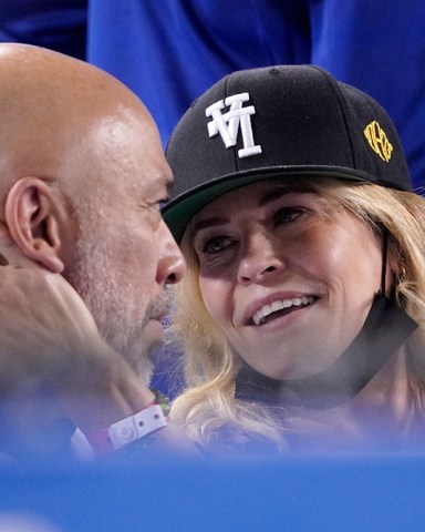 Actress Chelsea Handler, right, caresses the face of comedian Jo Koy before kissing him during the fifth inning of a baseball game between the Los Angeles Dodgers and the San Diego Padres, in Los Angeles Padres Dodgers Baseball, Los Angeles, United States - 28 Sep 2021