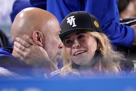 Actress Chelsea Handler, right, caresses the face of comedian Jo Koy before kissing him during the fifth inning of a baseball game between the Los Angeles Dodgers and the San Diego Padres, in Los Angeles Padres Dodgers Baseball, Los Angeles, United States - 28 Sep 2021