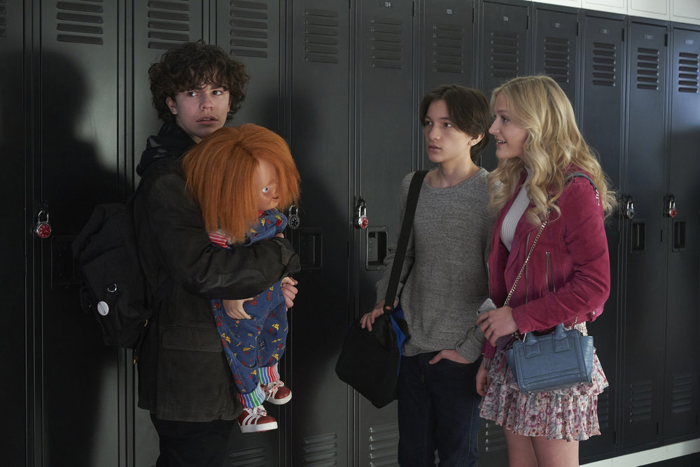 CHUCKY -- "Death by Misadventure" Episode 101 -- Pictured: (l-r) Zackary Arthur as Jake Wheeler, Chucky, Teo Briones as Junior Wheeler, Alyvia Alyn Lind as Lexy Cross -- (Photo by: Steve Wilkie/USA Network)