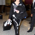 Khloe Kardashian wears a skeleton onesie on Halloween while arriving in Toronto