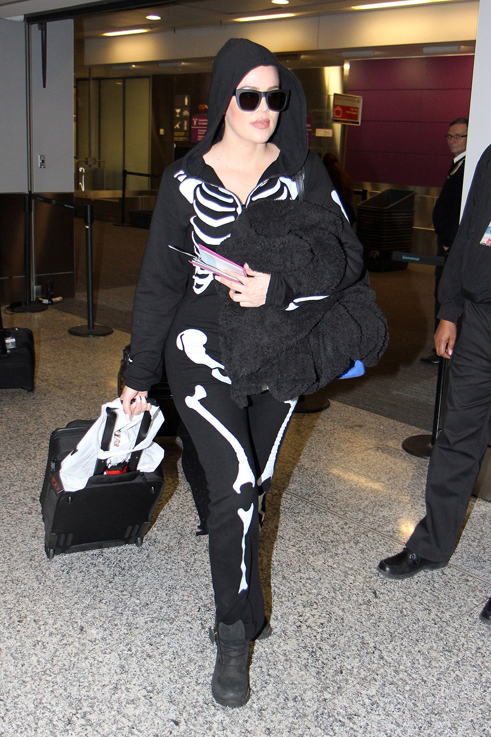 Khloe Kardashian wears a skeleton onesie on Halloween while arriving in Toronto