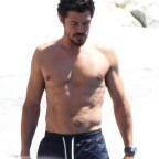 Shirtless Orlando Bloom, 46, displays his washboard abs at hotel Eden Roc in Cannes