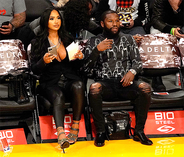 Floyd Mayweather looks downcast while sitting courtside at Los