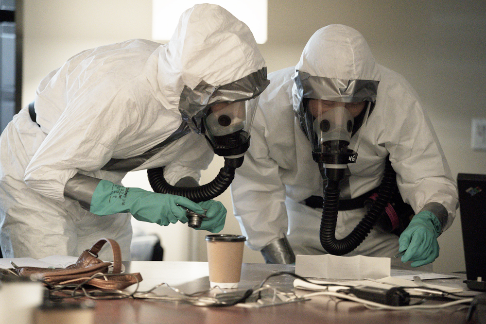 Agent Dani Toretti and Special Agent Matthew Ryker, played by Dawn Olivieri and Daniel Dae Kim, examine the Daschle letter. (National Geographic/Peter Stranks)