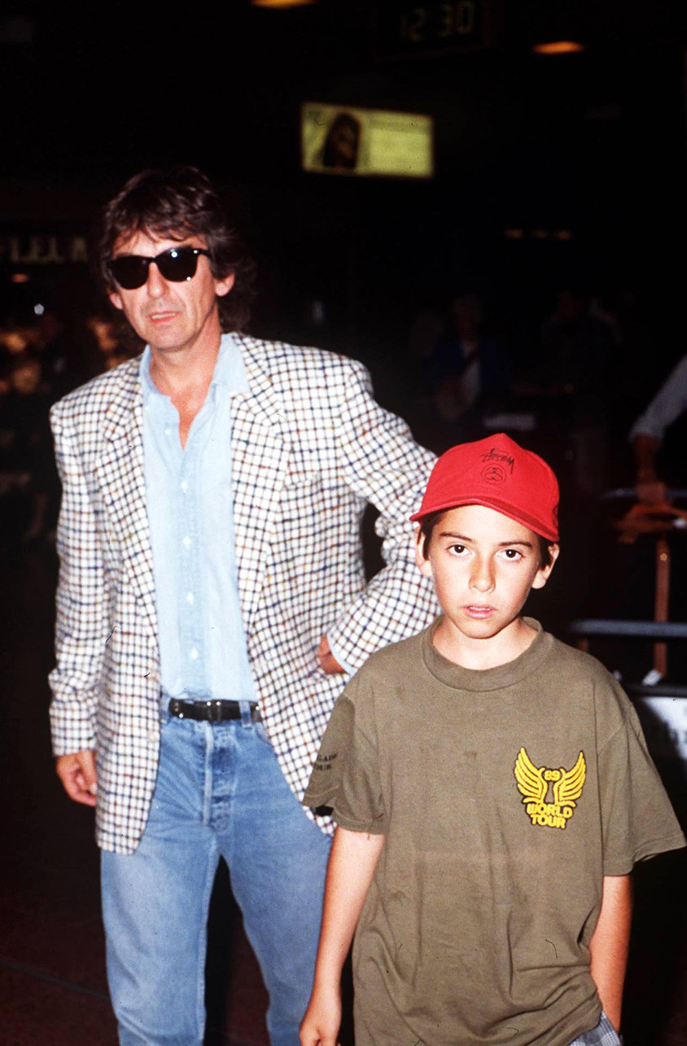 GEORGE HARRISON WITH HIS SON DHANI AT LONDON HEATHROW AIRPORT, BRITAIN - 1990