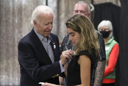 President Joe Biden puts a "I voted" Wilmington, Del Election 2022 Biden Votes Sticker on his granddaughter Natalie Biden after voting during early voting for the 2022 US midterm elections in Wilmington, United States - October 29, 2022