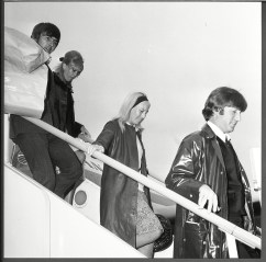 John Lennon His Wife Cynthia Lennon And Fellow Beatle George Harrison Disembark From A Plane As They Return From Their Holiday. John Lennon His Wife Cynthia Lennon And Fellow Beatle George Harrison Disembark From A Plane As They Return From Their Holiday.