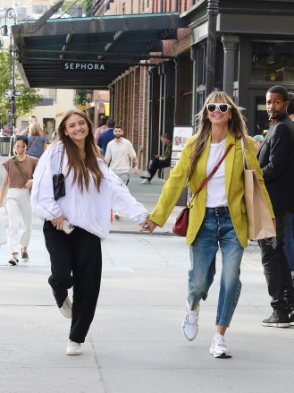 New York City, NY - *EXCLUSIVE* - Heidi Klum and daughter Leni hold hands as they jump and skip with joy while shopping in Manhattan's Meatpacking District.  The mother and daughter were seen bonding and full of happiness during their shopping spree.  Pictured: Heidi Klum, Leni Klum BACKGRID USA 8 SEPTEMBER 2022 BYLINE MUST READ: BrosNYC / BACKGRID USA: +1 310 798 9111 / usasales@backgrid.com UK: +44 208 344 2007 / uksales@backgrid.com *UK Clients - Pictures Containing Children Please Pixelate Face Prior To Publication*