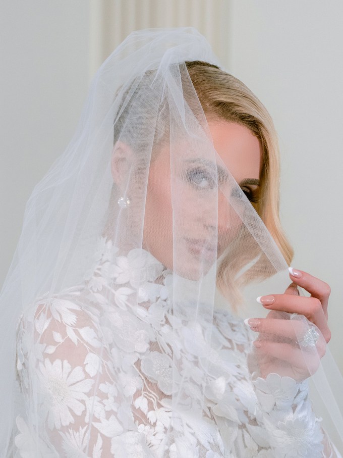 Paris Hilton peeking through her veil