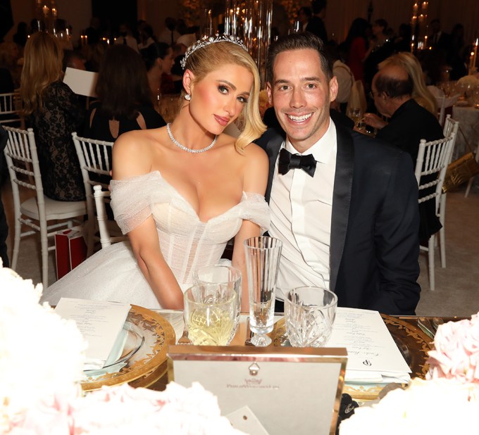 Paris Hilton and Carter Reum sitting at their table