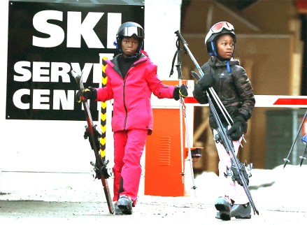 Gstaad, Switzerland - *EXCLUSIVE* - Madonna's twin daughters Estere and Stella (adopted), 9, and their Ski Instructor and Nanny on a cable car take them to the top of the ski , snacking on top of the slopes of Eggli in the popular ski resort of Gstaad, Switzerland.  Pictured: Estere, Stella BACKGRID USA JANUARY 2, 2022 USA: +1 310 798 9111 / usasales@backgrid.com UK: +44 208 344 2007 / uksales@backgrid.com * UK Customers - Pictures With Children em Please focus the face before publishing *