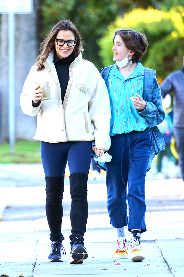 Jennifer Garner wears a teddy jacket with leggings and leg warmers while  out on a walk