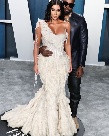 Television personality Kim Kardashian West wearing an Alexander McQueen dress and Lorraine Schwartz jewelry and husband/rapper Kanye West wearing a Dunhill look arrive at the 2020 Vanity Fair Oscar Party held at the Wallis Annenberg Center for the Performing Arts on February 9, 2020 in Beverly Hills, Los Angeles, California, United States. 2020 Vanity Fair Oscar Party, Beverly Hills, United States - 10 Feb 2020