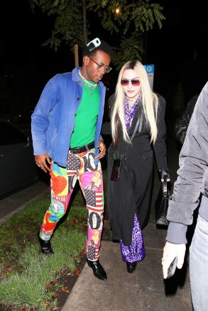 Los Angeles, CA - *EXCLUSIVE- Madonna and her boyfriend Ahlamalik Williams and her son, David Banda, arrive at Cecconi's for a late dinner. Madonna reportedly arrived around 12:30 am and had the place to herself. The pop superstar stepped out in a purple satin pajama style pant outfit with a. leopard print. She topped the look with a black coat and accessorized with a pair of leather fingerless gloves and a black crocodile Hermes bag blinged out in diamond studs spelling the word, DEALER. Madonna, 63 held on to her 27 year boyfriend, Ahlamalik Williams apparently to steady herself in a pair of platforms boots.Pictured: David Banda, MadonnaBACKGRID USA 20 JANUARY 2022 USA: +1 310 798 9111 / usasales@backgrid.comUK: +44 208 344 2007 / uksales@backgrid.com*UK Clients - Pictures Containing ChildrenPlease Pixelate Face Prior To Publication*