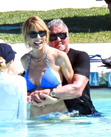 Sardinia, ITALY - 77-year-old American actor Sylvester Stallone is pictured with his wife Jennifer Flavin on vacation in Porto Cervo.  The happy couple looked relaxed as they played in the pool while enjoying a romantic getaway to Sardinia, Jennifer, 54, looked stunning in a blue bikini which showed off her enviable figure.  Photo: Sylvester Stallone - Jennifer Flavin BACKGRID USA 14 JULY 2023 REMARKS: The Cobra Team / BACKGRID USA: +1 310 798 9111 / usasales@backgrid.com UK: +44 208 344 2007 / Cbackgrids.com Images With Children Please Pixelate Before Download Face*