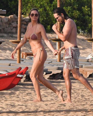 Sardegna, ITALY  - The German Supermodel Heidi Klum and her husband, the Tokio Hotel star Tom Kaulitz frolic out in the sea during the sun-soaked holiday at the beaches of Cala Volpe bay in Sardinia.  The couple packed on the PDA during the European heatwave that's currently gripping in the continent.  Pictured: Heidi Klum - Tom Kaulitz  BACKGRID USA 16 JULY 2023   BYLINE MUST READ: Frezza La Fata - Cobra Team / BACKGRID  USA: +1 310 798 9111 / usasales@backgrid.com  UK: +44 208 344 2007 / uksales@backgrid.com  *UK Clients - Pictures Containing Children Please Pixelate Face Prior To Publication*