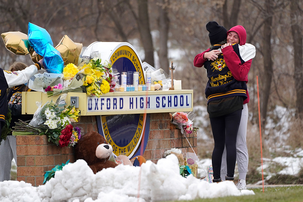 Students hug at a memorial at Oxford High School in Oxford, Mich., . Authorities say a 15-year-old sophomore opened fire at Oxford High School, killing four students and wounding seven other people on Tuesday
School Shooting Michigan, Oxford, United States - 01 Dec 2021