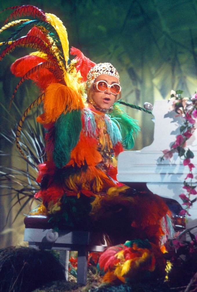 Elton John Dons Colorful Feathers