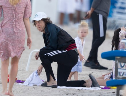 EXCLUSIVE: Mick Jagger is seen playing with his son and being comforted by his girlfriend Melanie Hamrick on their balcony in Miami. 31 Mar 2019 Pictured: Mick Jagger is seen playing with his son and being comforted by his girlfriend Melanie Hamrick on their balcony in Miami. Photo credit: Splash/MEGA TheMegaAgency.com +1 888 505 6342 (Mega Agency TagID: MEGA391806_011.jpg) [Photo via Mega Agency]