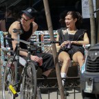Bella Hadid and her boyfriend Marc Kalman seen all smiling while relaxing on a bench outside their gym in NYC