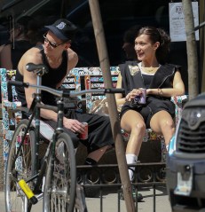 Bella Hadid and her boyfriend Marc Kalman seen all smiling while relaxing on a bench outside their gym in NYC. 14 Apr 2022 Pictured: Bella Hadid and Marc Kalman. Photo credit: ZapatA/MEGA TheMegaAgency.com +1 888 505 6342 (Mega Agency TagID: MEGA848352_001.jpg) [Photo via Mega Agency]