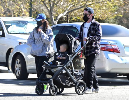 EXCLUSIVE: Macaulay Culkin and Brenda Song take their new baby to the LA zoo, Macaulay can be seen tugging on her vape pen while pushing her baby in her stroller.  **SPECIAL INSTRUCTIONS*** Please rasterize children's faces before publishing.***.  03 February 2022 Pictured: Macaulay Culkin and Brenda Song.  Photo Credit: P&P / MEGA TheMegaAgency.com +1 888 505 6342 (Mega Agency TagID: MEGA825448_018.jpg) [Photo via Mega Agency]