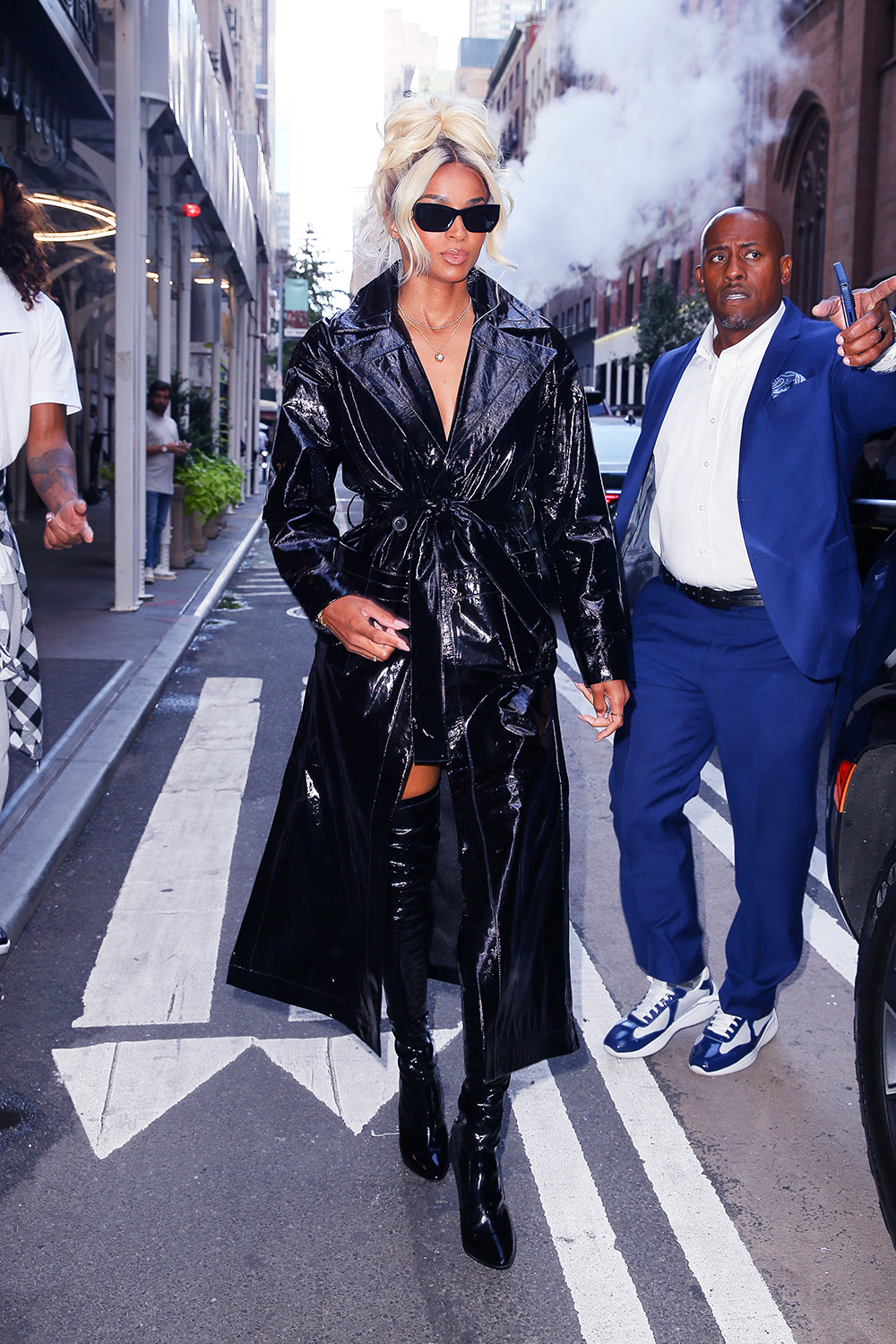 Ciara Wears A Black Vinyl Coat And Thigh-High Boots During New York Fashion Week 2022