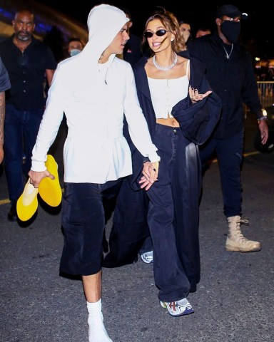 *EXCLUSIVE* Inglewood, CA  - Justin Bieber walks barefoot with his wife Hailey Bieber holding his Adidas Yeezy's in his hand after the Rams win Super Bowl LVI at SoFi Stadium in Inglewood, California  Pictured: Justin Bieber, Hailey Bieber  BACKGRID USA 13 FEBRUARY 2022   USA: +1 310 798 9111 / usasales@backgrid.com  UK: +44 208 344 2007 / uksales@backgrid.com  *UK Clients - Pictures Containing Children Please Pixelate Face Prior To Publication*