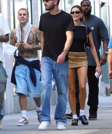 New York, NY - *EXCLUSIVE*Hot in the City? Justin Bieber goes shirtless showing off his and Calvin Klein's tattoos at an outing with his wife Hailey and friends in Tribeca, New York on Wednesday in photo: Justin Bieber, Hailey Bieber BACKGRID USA MAY 11, 2023 USA: +1 310 798 9111 / usasales@backgrid.com United Kingdom: +44 208 344 2007 / uksales@backgrid.com *UK customers - Images containing children must be pixelated before publishing*