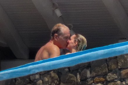 EXCLUSIVE: Swedish actor Dolph Lundgren goes shirtless during a romantic vacation in Greece with his much younger fiancee Emma Krokdal amid his lengthy cancer battle. The 65-year-old movie star and the 25-year-old Norwegian beauty were seen kissing as they enjoyed a sunsoaked break in Mykonos. The trip comes after the 'Rocky IV' star revealed he has been battling lung cancer for eight years and speculated whether his past use of steroids for bodybuilding is to blame. The couple were joined in Greece by Dolph's model daughter Ida Lundgren, 27. Despite their 40-year age gap, Dolph has spoken about how mature his lady love is for her age. 13 Jul 2023 Pictured: Dolph Lundgren, Emma Krokdal. Photo credit: A LONE WOLF/MEGA TheMegaAgency.com +1 888 505 6342 (Mega Agency TagID: MEGA1006850_001.jpg) [Photo via Mega Agency]