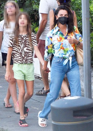 Portofino, ITALY  - *EXCLUSIVE*  - Spanish Actress Penelope Cruz dons her summery floral patterned blouse top and jeans out with her children on holiday at the Hotel Astoria in Rapallo.  Penelope on her European break is still being extra careful about the ongoing threat of COVID-19 by wearing her face mask with her two children Luna and Leo.  The Vicky Cristina Barcelona actress and Javier Bardem's wife had previously expressed that she would love to make a musical film with her husband after seeing him belt out some tunes in Being the Ricardos according to reports. **SHOT ON 07/29/22**  Pictured: Penelope Cruz  BACKGRID USA 15 AUGUST 2022   USA: +1 310 798 9111 / usasales@backgrid.com  UK: +44 208 344 2007 / uksales@backgrid.com  *UK Clients - Pictures Containing Children Please Pixelate Face Prior To Publication*