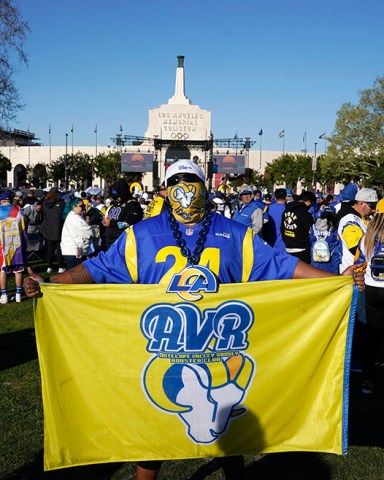 Fan holds a flag near Los Angeles Memorial Coliseum before the Los Angeles Rams' victory parade, in Los Angeles, following the Rams' win Sunday over the Cincinnati Bengals in the NFL Super Bowl 56 football gameRams Parade Football, Los Angeles, United States - 16 Feb 2022