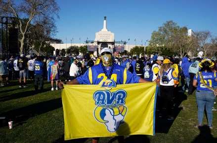 Fan holds a flag near Los Angeles Memorial Coliseum before the Los Angeles Rams' victory parade, in Los Angeles, following the Rams' win Sunday over the Cincinnati Bengals in the NFL Super Bowl 56 football gameRams Parade Football, Los Angeles, United States - 16 Feb 2022