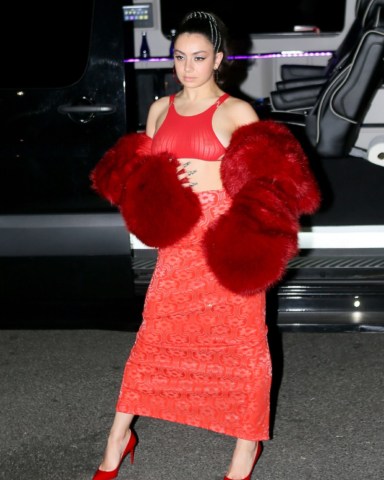 New York city, NY  - Popstar Charlie XCX is sizzling hot donning a red gown accompanied by a matching fur BOA while out in New York. Charlie makes time to strike a pose after performing at Manhattan Center.  Pictured: Charli XCX  BACKGRID USA 23 APRIL 2022   BYLINE MUST READ: T.JACKSON / BACKGRID  USA: +1 310 798 9111 / usasales@backgrid.com  UK: +44 208 344 2007 / uksales@backgrid.com  *UK Clients - Pictures Containing Children Please Pixelate Face Prior To Publication*