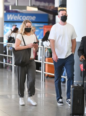 NEW YORK CITY, NY - *Special* Jennifer Lawrence and husband Cooke Maroney arrive at JFK Airport in New York City.  Image: Jennifer Lawrence, Cook Maroney Backgrid USA 7 August 2022 USA: +1 310 798 9111 / usasales@backgrid.com UK: +44 208 344 2007 / uksales@backgrid.com * UK Customers - Images involving children Please face first Pixelate Publication*