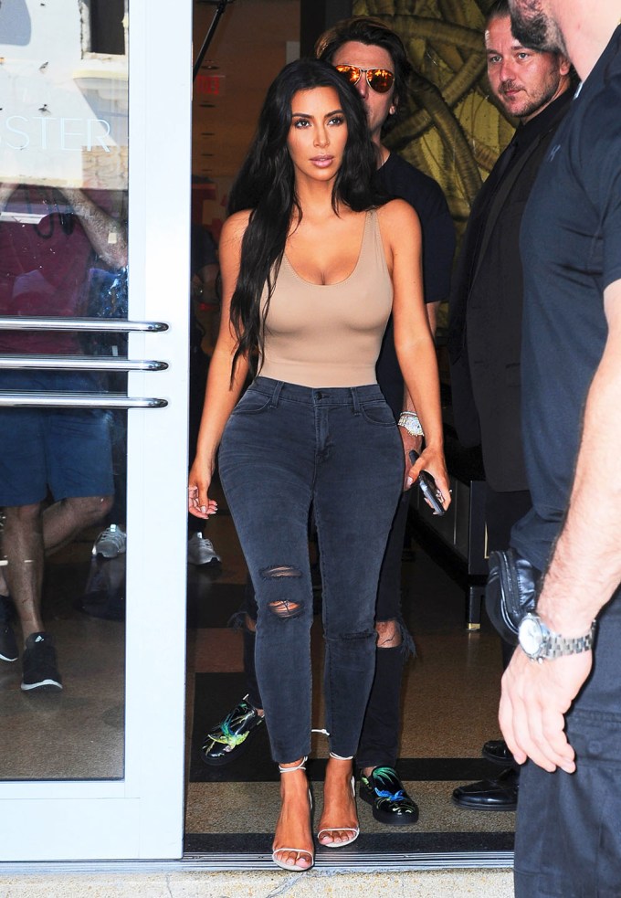 Kim Kardashian wears a Maximilian Spring 2022 bonded scuba bodysuit and  paired it with black ripped baggy jeans, more than likely Balenci