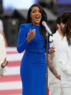 Mickey Guyton rocks a figure-hugging blue gown while singing the