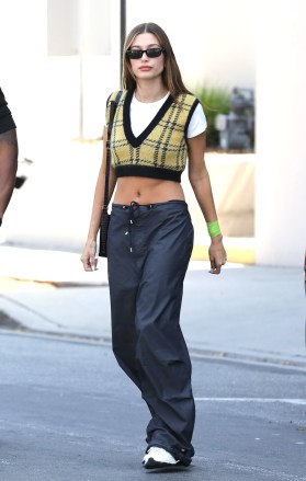 Santa Monica, CA  - *EXCLUSIVE*  - Supermodel Hailey Bieber is looking slim as we catch her grabbing a juice at Erewhon wearing large wide leg pants and showing off her abs in a cropped sweater vest.  Pictured: Hailey Bieber  BACKGRID USA 5 MAY 2022   BYLINE MUST READ: Vasquez-Max Lopes / BACKGRID  USA: +1 310 798 9111 / usasales@backgrid.com  UK: +44 208 344 2007 / uksales@backgrid.com  *UK Clients - Pictures Containing Children Please Pixelate Face Prior To Publication*