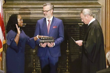 In this image from video provided by the Supreme Court, Chief Justice of the United States John Roberts administers the Constitutional Oath to Ketanji Brown Jackson as her husband Patrick Jackson holds the Bible at the Supreme Court in Washington
Supreme Court Jackson, Washington, United States - 30 Jun 2022