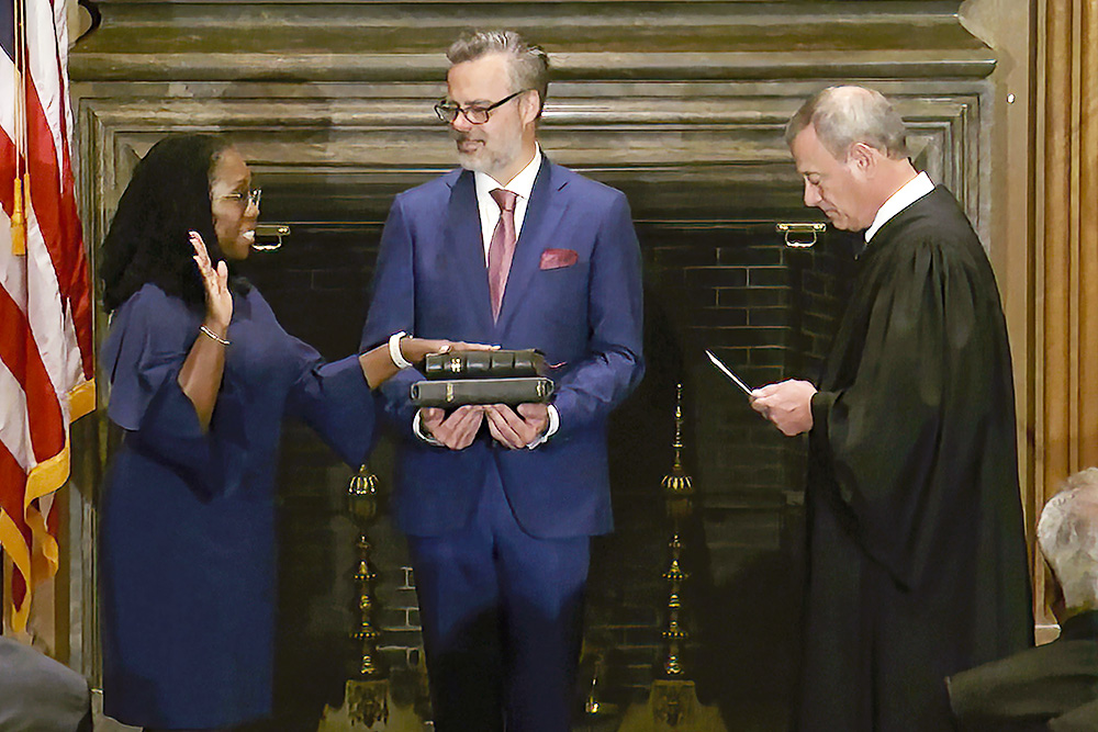 In this still from video provided by the Supreme Court, United States Chief Justice John Roberts administers the constitutional oath to Ketanji Brown Jackson as her husband Patrick Jackson holds the Bible in Washington Supreme Court Supreme Court Jackson, Washington, USA - June 30, 2022