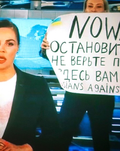 A woman watches a recorded feed of the Russian Channel One's evening news broadcast TV show in which an employee enters Ostankino on-air TV studio with a poster reading ''No War. Stop the war. Don't believe the propaganda. You are being lied to here" in Moscow, Russia, 15 March 2022. The on-air protest was staged on 14 March by Marina Ovsyannikova, who worked as an editor. She was taken to the Ostankino police department. A protocol was drawn up against an employee of Channel One under the article on military censorship for discrediting the Russian armed forces. On 24 February Russian troops had entered Ukrainian territory in what the Russian president declared a 'special military operation', resulting in fighting and destruction in the country, a huge flow of refugees, and multiple sanctions against Russia.
The on-air protest on Russian TV against Russian military operation in Ukraine, Moscow, Russian Federation - 15 Mar 2022