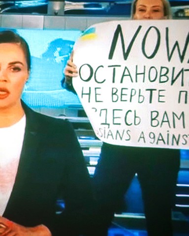 A woman watches a recorded feed of the Russian Channel One's evening news broadcast TV show in which an employee enters Ostankino on-air TV studio with a poster reading ''No War. Stop the war. Don't believe the propaganda. You are being lied to here" in Moscow, Russia, 15 March 2022. The on-air protest was staged on 14 March by Marina Ovsyannikova, who worked as an editor. She was taken to the Ostankino police department. A protocol was drawn up against an employee of Channel One under the article on military censorship for discrediting the Russian armed forces. On 24 February Russian troops had entered Ukrainian territory in what the Russian president declared a 'special military operation', resulting in fighting and destruction in the country, a huge flow of refugees, and multiple sanctions against Russia. The on-air protest on Russian TV against Russian military operation in Ukraine, Moscow, Russian Federation - 15 Mar 2022
