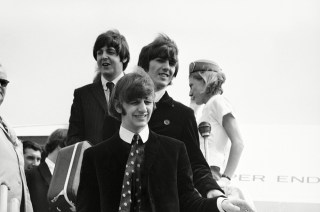 The Beatles leave a Pan Am plane to transfer to another in Boston, Mass., after a flight from London. A crowd of 600 greeted them but few got to see the Beatles, who are en route to Chicago where they will start their third tour of American cities. From top: Paul McCartney, George Harrison and Ringo Starr
The Beatles 1966, Boston, USA