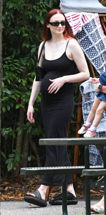 EXCLUSIVE: Sophie Turner shows off her growing baby bump in a tight maxi dress as she and husband Joe Jonas hit up a crowded farmers market in Miami.  Joe showed off is a unique sense of style in a bright floral shirt, painted nails, and a leather bag.  03 Apr 2022 Pictured: Joe Jonas, Sophie Turner.  Photo credit: MEGA TheMegaAgency.com +1 888 505 6342 (Mega Agency TagID: MEGA844412_003.jpg) [Photo via Mega Agency]