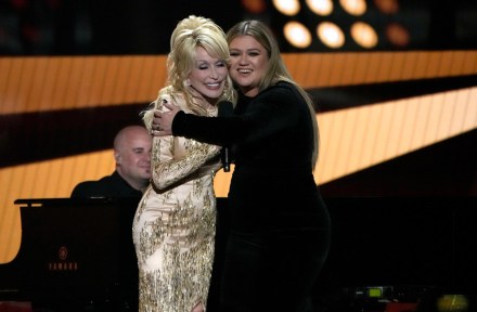Dolly Parton, left, and Kelly Clarkson embrace onstage at the 57th Academy of Country Music Awards, at Allegiant Stadium in Las Vegas
57th ACM Awards - Show, Las Vegas, United States - 07 Mar 2022